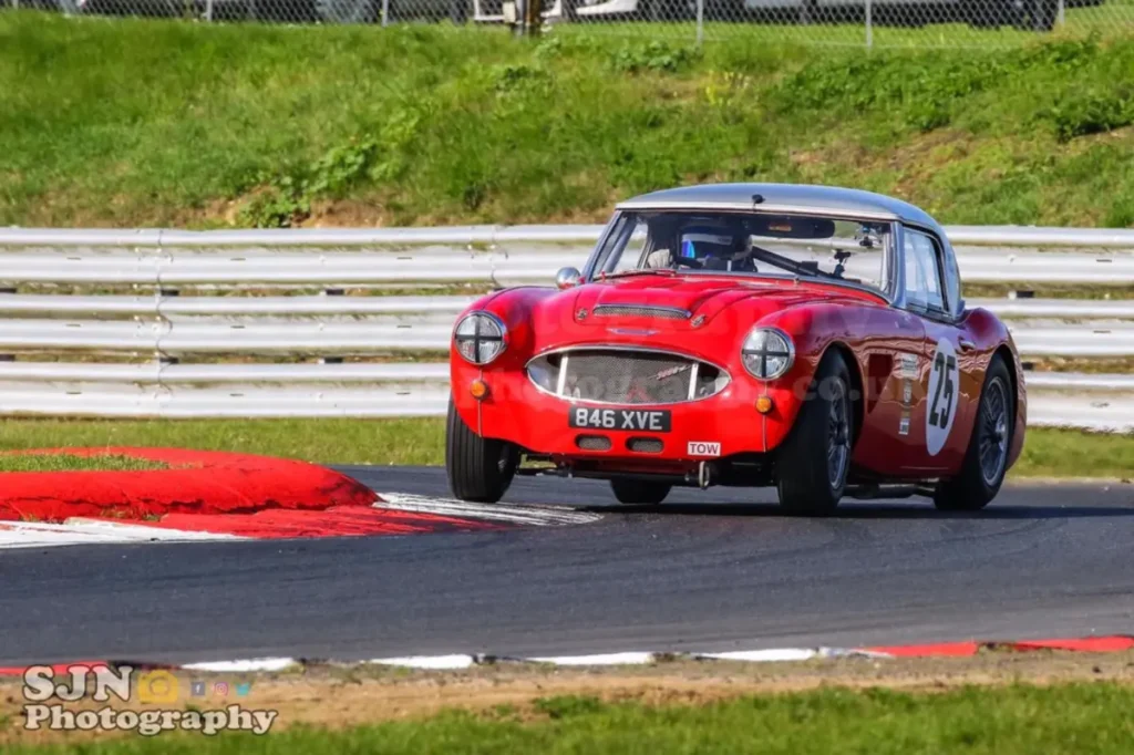 Throwing the Healey around a bend on teh track